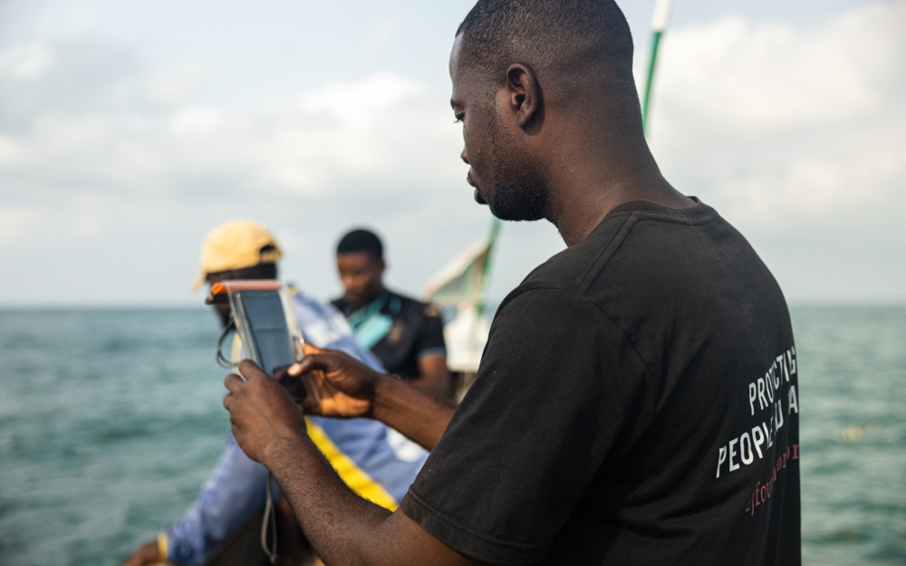 Fishers and EJF staff using the DASE app at sea in Gomoa Fetteh Ghana